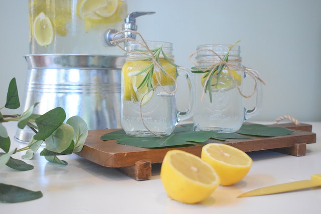 Mason glasses with clear liquid and lemon slices