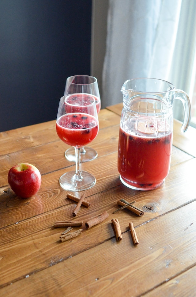 Red-colored beverage flavored with apple and cinnamon