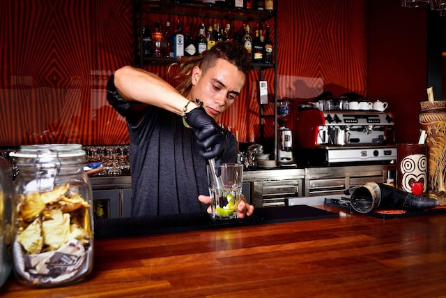 Bartender making a drink at the counter